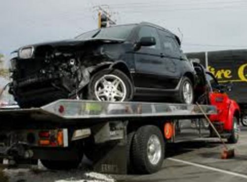 Junk Car Being Towed